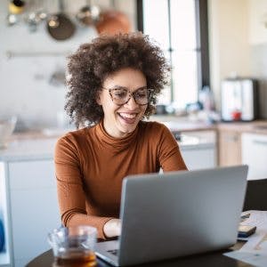 Happy Homeowner Checking Options On How Much Money She Can Access On Her Home Equity