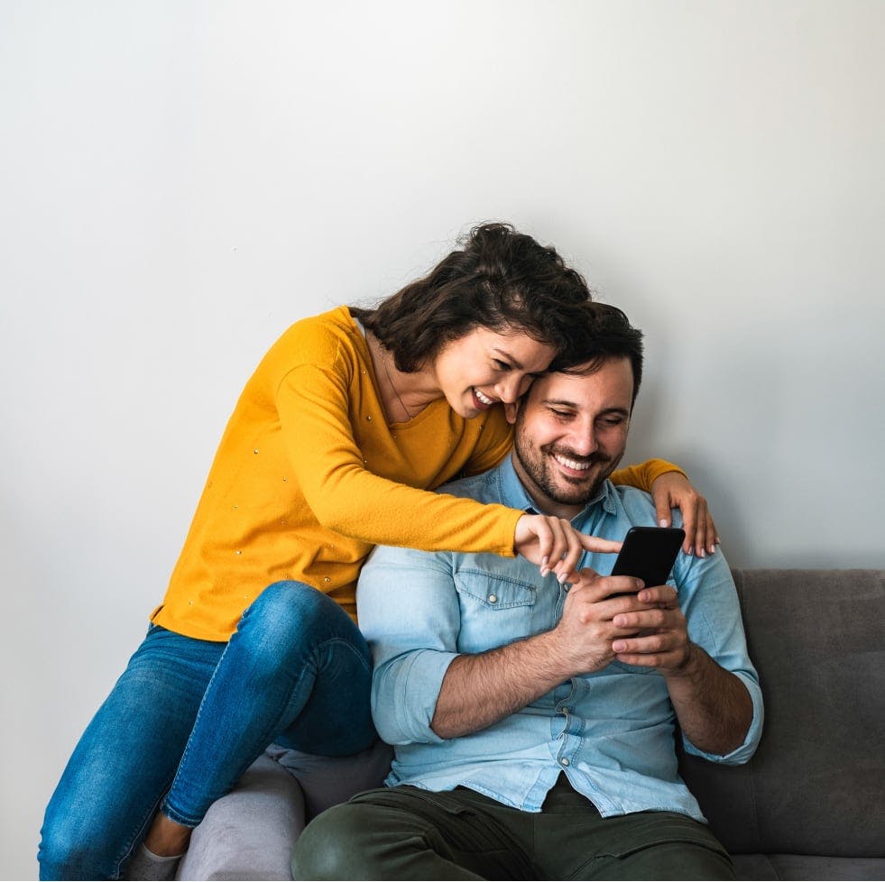 Couple with their newborn child happy after a successful cash-out refinance through House Numbers